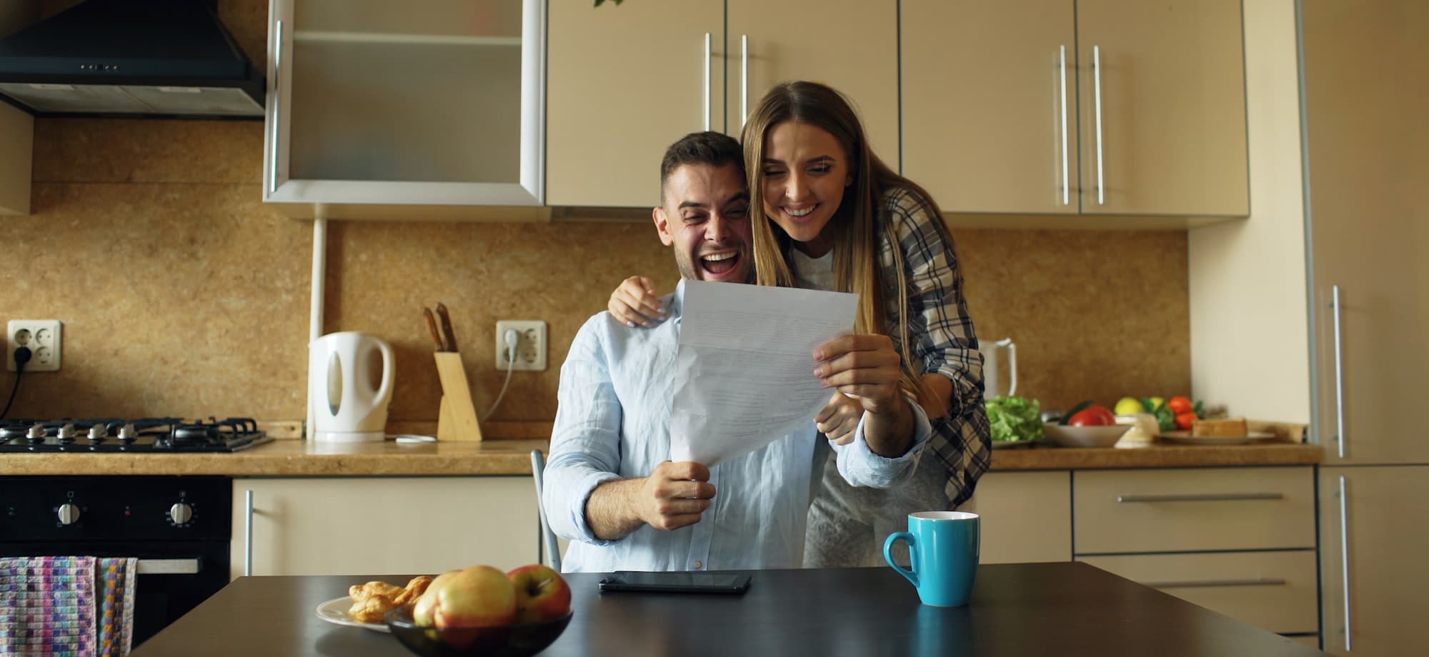 A couple reading a property report together at their kitchen table